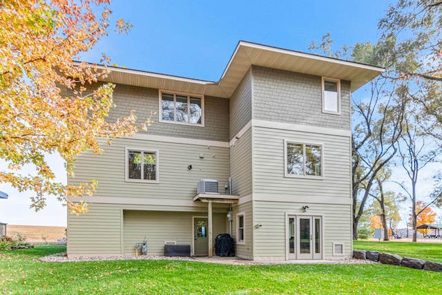 rear view of house featuring a yard, french doors, and a patio