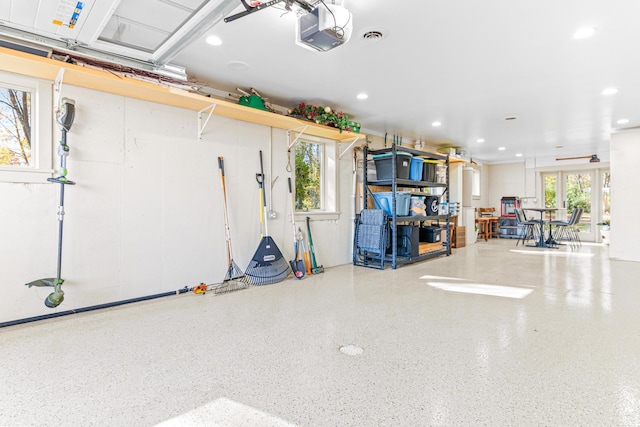 garage featuring recessed lighting, visible vents, and a garage door opener