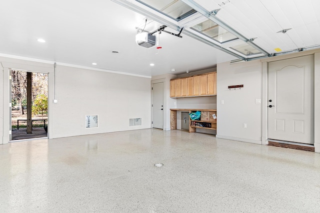 garage featuring a garage door opener, recessed lighting, and visible vents