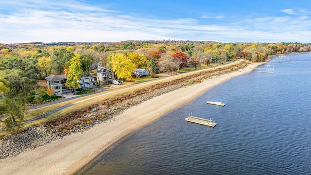 aerial view with a water view and a forest view