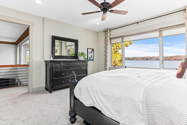 carpeted bedroom with recessed lighting, a water view, baseboards, and ceiling fan