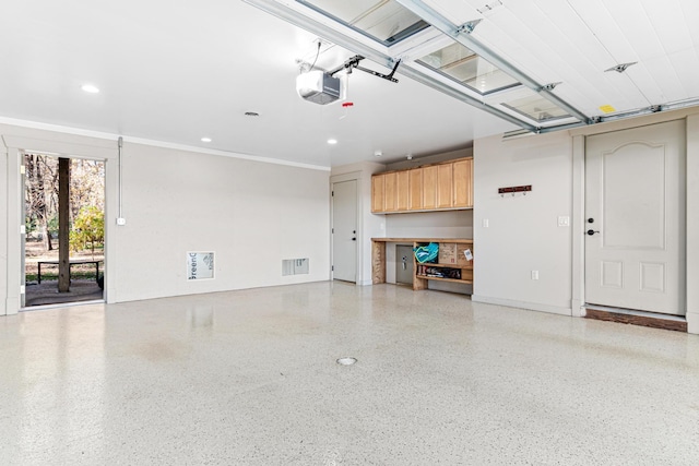 garage featuring a garage door opener, visible vents, and recessed lighting