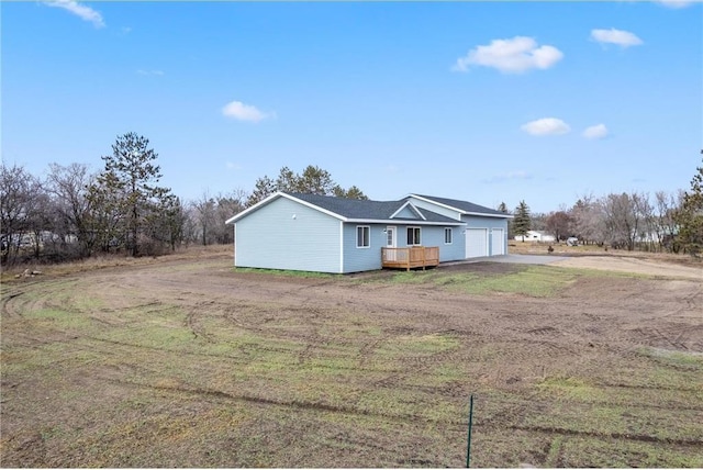 back of property featuring a garage and driveway