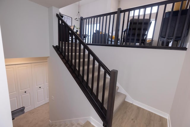 stairway with carpet and baseboards