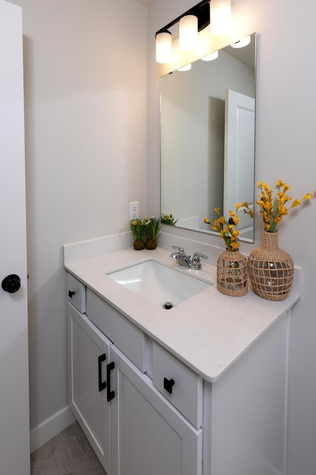 bathroom featuring vanity and baseboards