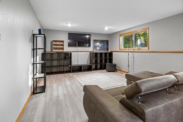 living area with wood finished floors and baseboards