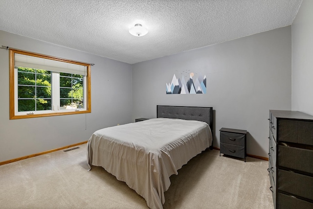 bedroom featuring baseboards, visible vents, and light colored carpet