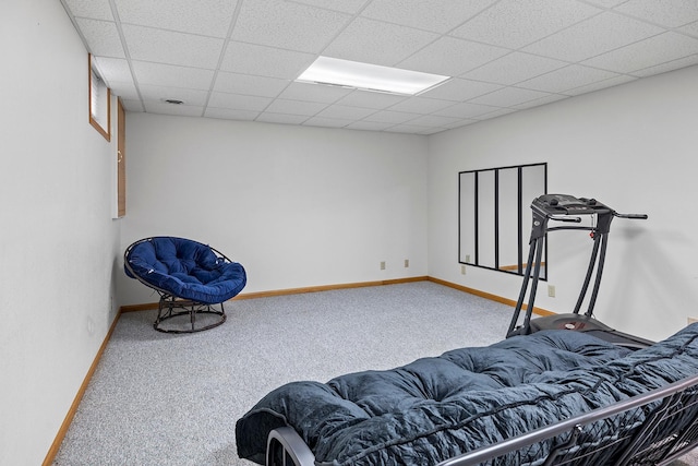 carpeted bedroom with baseboards and a drop ceiling