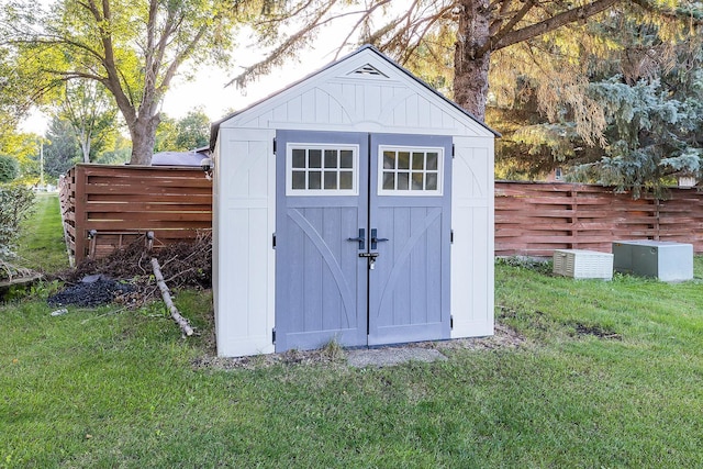 view of shed featuring fence