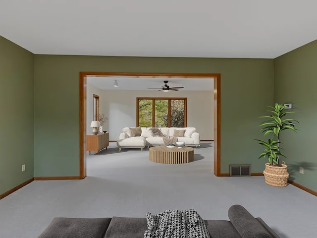 carpeted living area featuring visible vents and baseboards