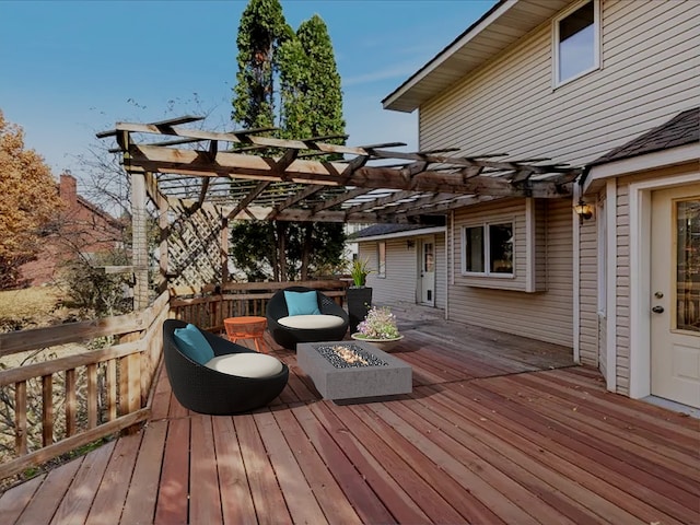 wooden terrace featuring a fire pit and a pergola