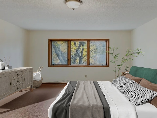 bedroom with carpet flooring and a textured ceiling