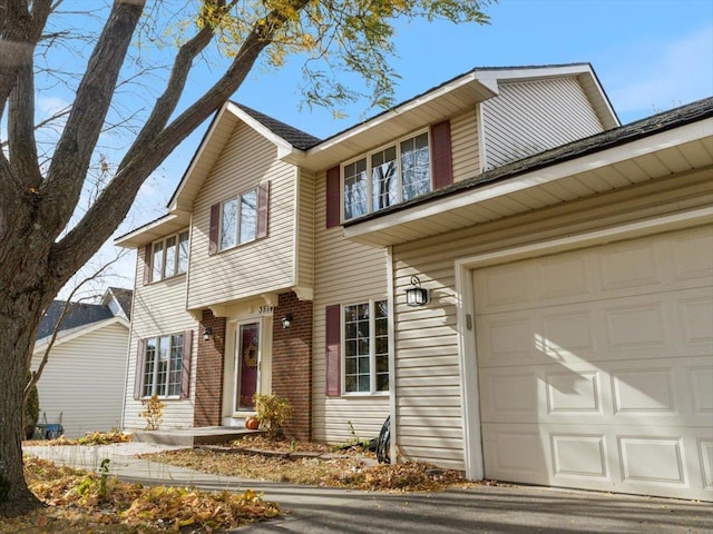 view of front of house with a garage and brick siding