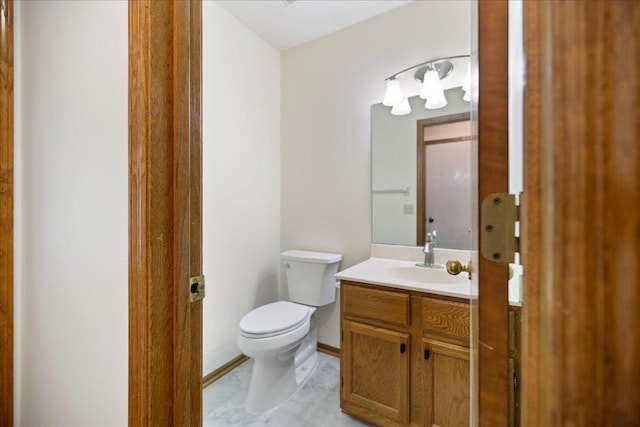 half bathroom with toilet and vanity