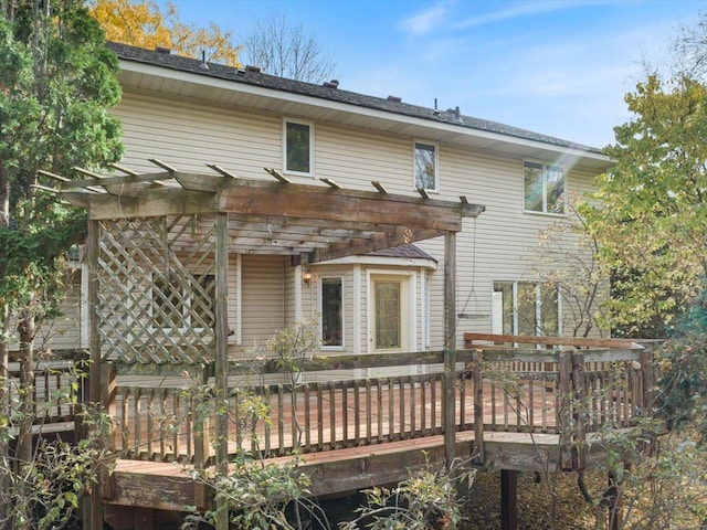 back of house featuring a wooden deck and a pergola