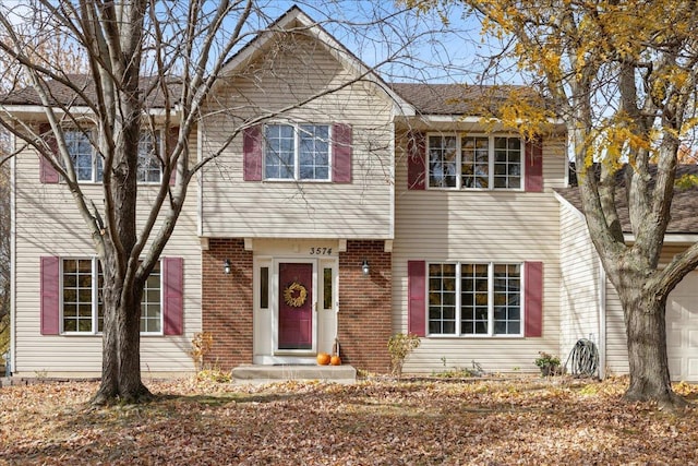 view of front facade featuring brick siding and an attached garage