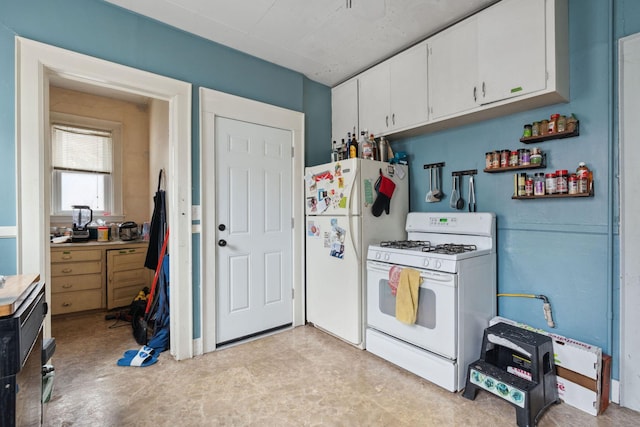 kitchen featuring white appliances and white cabinetry