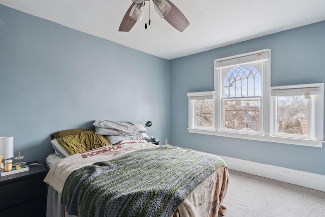 bedroom with carpet floors, a ceiling fan, and baseboards