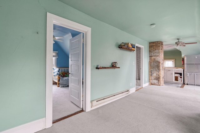 interior space featuring baseboards, a baseboard heating unit, and carpet flooring