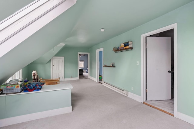 additional living space featuring vaulted ceiling, carpet floors, a baseboard radiator, and baseboards