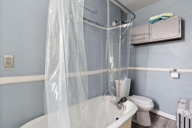 bathroom featuring radiator, shower / bathtub combination with curtain, toilet, and wood finished floors