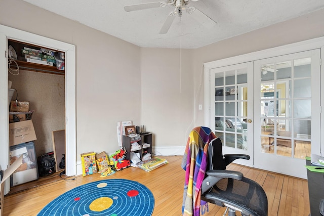 office area featuring french doors, wood-type flooring, a ceiling fan, and baseboards