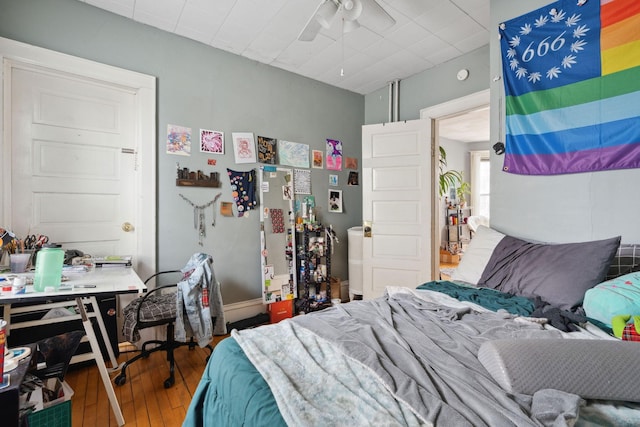 bedroom with ceiling fan and hardwood / wood-style flooring