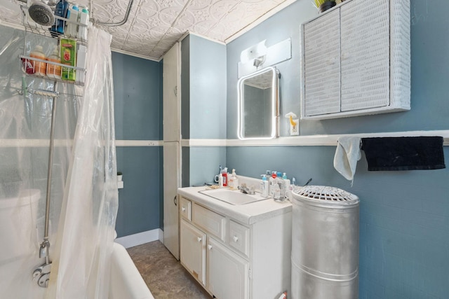 bathroom featuring an ornate ceiling, shower / bathtub combination with curtain, and vanity