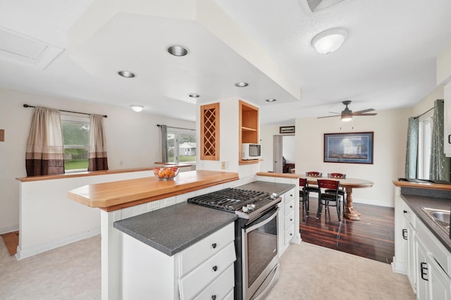 8527 10th Ave S, Bloomington, MN 55420 - kitchen featuring stainless steel range with gas cooktop, dark countertops, white cabinets, a ceiling fan, and recessed lighting