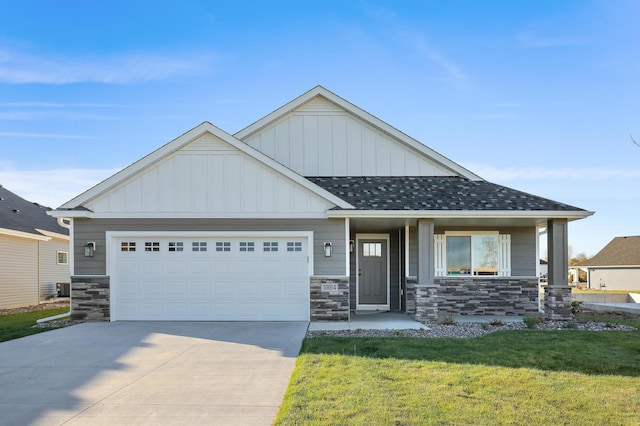 view of front of home with an attached garage, driveway, roof with shingles, a front lawn, and board and batten siding