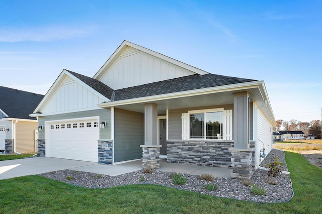 view of front of property featuring a shingled roof, stone siding, an attached garage, a porch, and board and batten siding