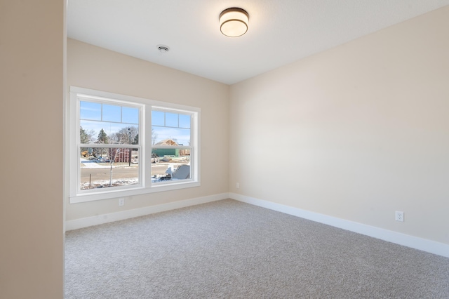 spare room with carpet floors and baseboards