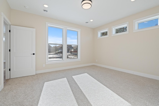 carpeted spare room with recessed lighting, plenty of natural light, and baseboards