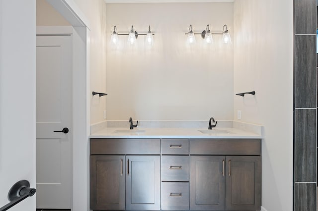 bathroom featuring a sink and double vanity