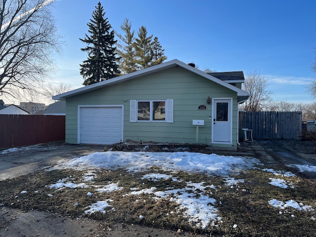 view of front of house featuring driveway and fence