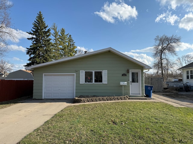 ranch-style house featuring driveway, fence, a garage, and a front yard
