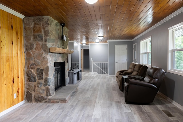 living area with wooden ceiling, a fireplace, crown molding, and wood finished floors