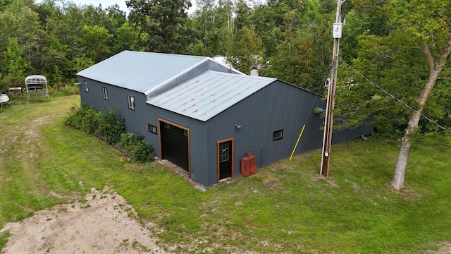 drone / aerial view featuring a wooded view