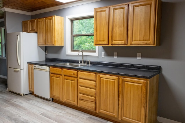 kitchen with dark countertops, light wood-style floors, ornamental molding, a sink, and white appliances