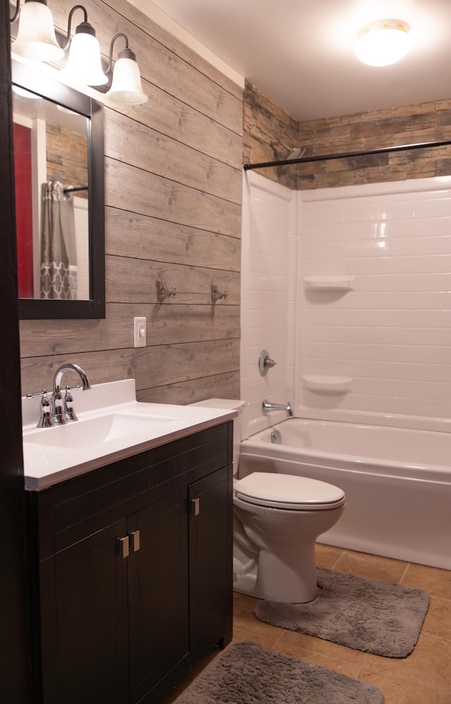 full bathroom with toilet, shower / bath combo, wooden walls, vanity, and tile patterned flooring