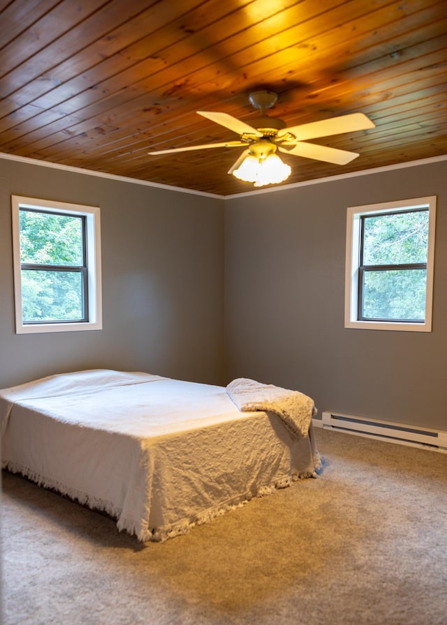 bedroom featuring wood ceiling, ceiling fan, crown molding, carpet floors, and a baseboard heating unit