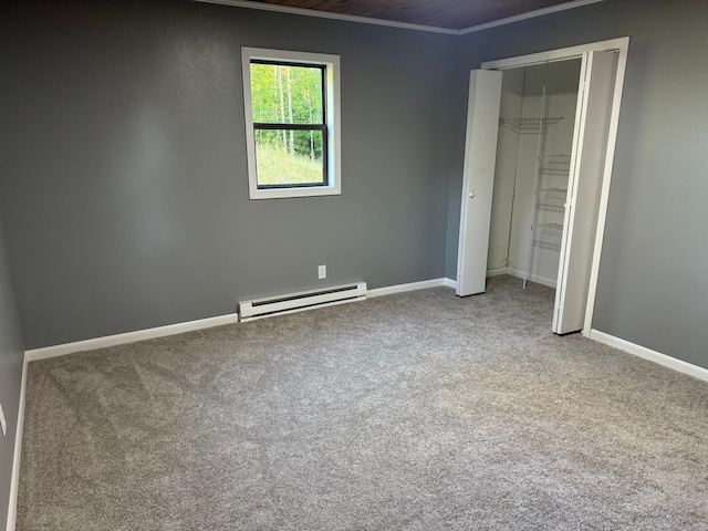 unfurnished bedroom with carpet flooring, baseboards, ornamental molding, a closet, and baseboard heating