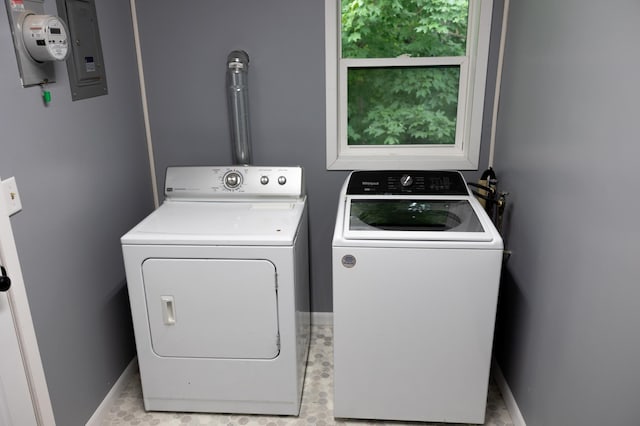 washroom featuring baseboards, laundry area, and washer and dryer