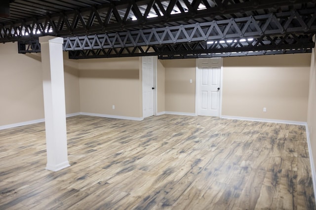 below grade area featuring baseboards and wood finished floors