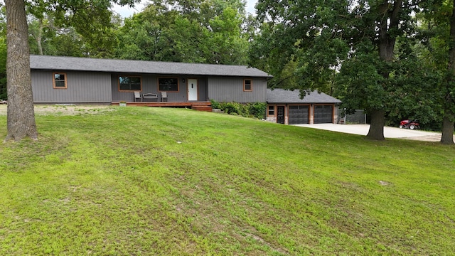 view of front of home featuring an attached garage, a porch, a front lawn, and concrete driveway