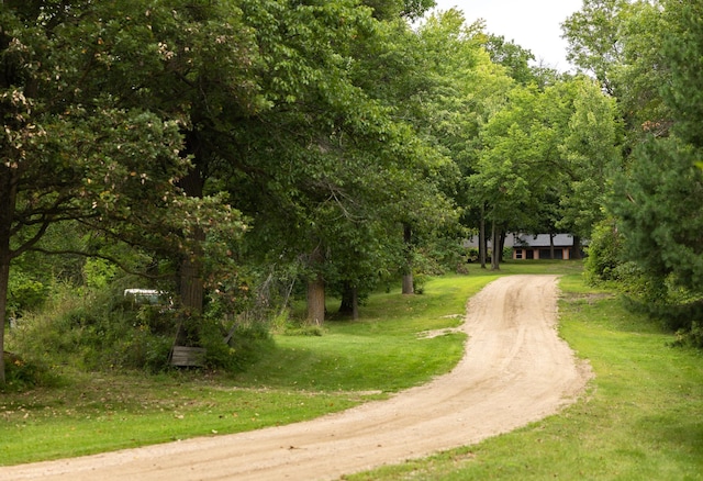 view of community with driveway and a lawn