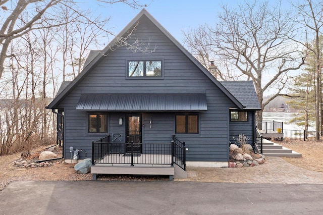 chalet / cabin with a chimney and fence