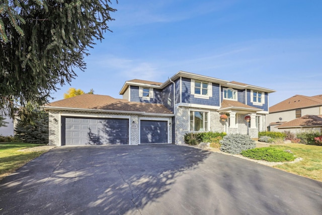 view of front of home featuring a garage, brick siding, and driveway