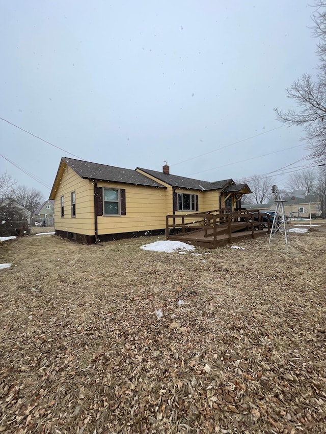 back of house featuring a wooden deck