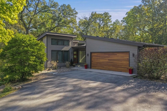 contemporary home with driveway and a garage